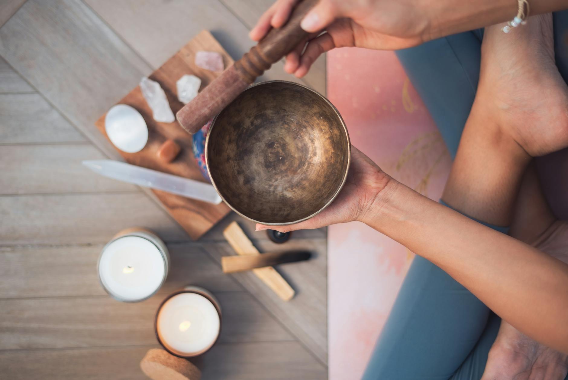 overhead shot of a person holding a tibetan singing bowl